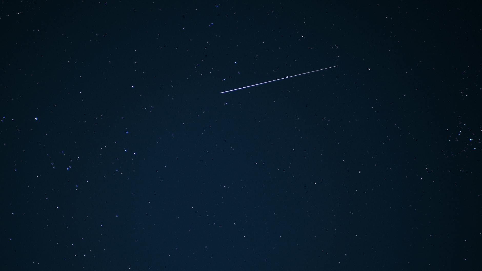 Spadająca gwiazda na tle gwiaździstego, przejrzystego nocnego nieba